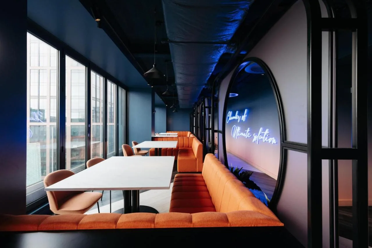 a row of tables and couches in a restaurant at Yotel Glasgow in Glasgow